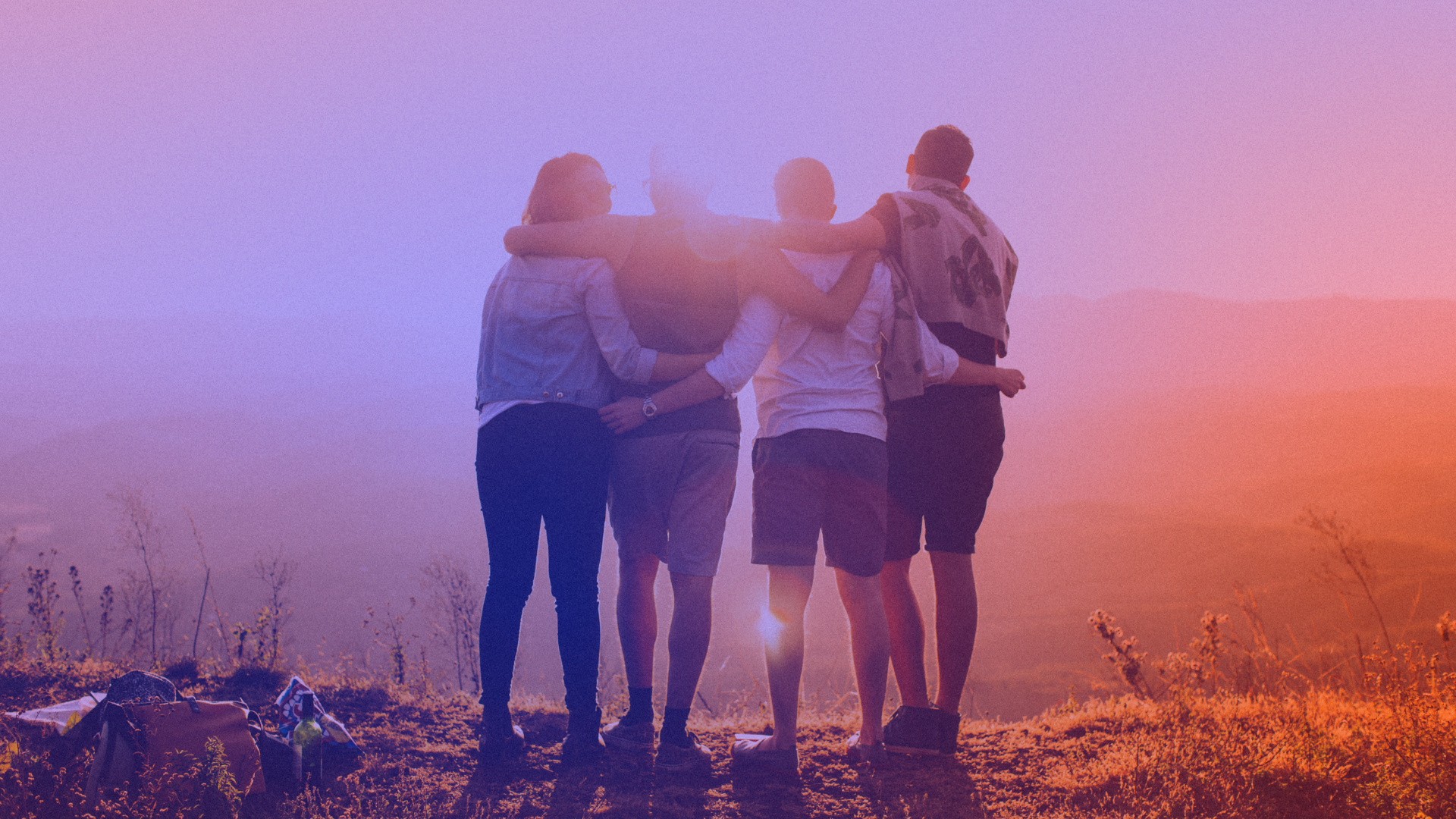 A group of young people hugging as a symbol of the importance of empathy in marketing.