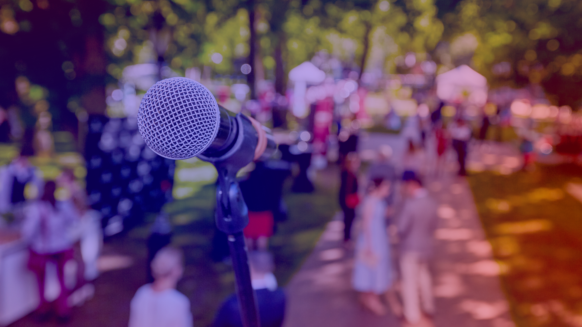Community building at an open-mic event with an audience in the background 